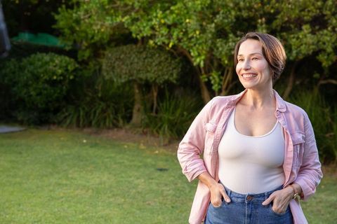 Senior Woman Relaxing with Smile Outdoors in Backyard Garden
