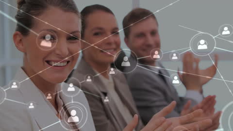 Diverse Business Team Celebrating Office Connectivity with Networking Graphics