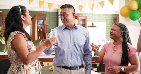 Senior Group Toasting with Wine at a Festive Birthday Celebration