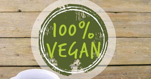 100 percent vegan text over bowl of fresh fruit