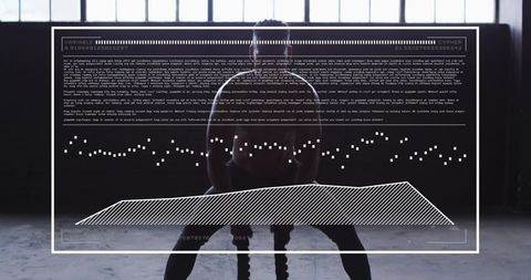 Backlit male athlete gripping battle rope in industrial warehouse gym with hud overlay