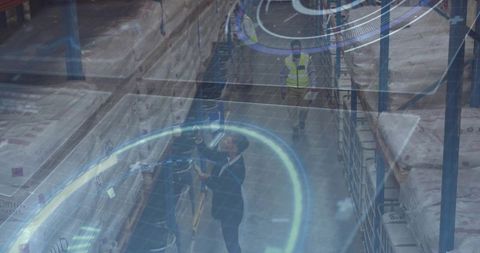 Warehouse supervisor managing inventory with modern technology