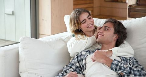 Romantic Couple Relaxing on Sofa in Modern Living Room