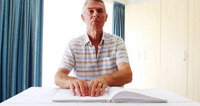 Elderly Man Reading Braille Book at Home Table - Download Free Stock Images Pikwizard.com