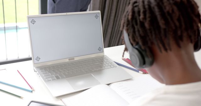 Student with Headphones Studying at Desk with Modern Laptop - Download Free Stock Images Pikwizard.com