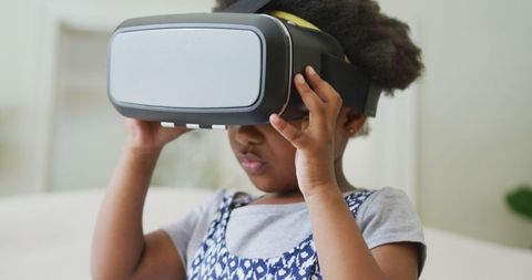 Young Girl Exploring VR Technology in Cozy Living Space
