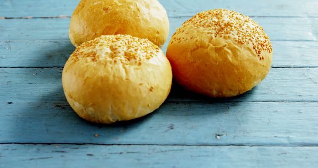 Freshly Baked Round Bread Rolls on Blue Wooden Surface - Download Free Stock Images Pikwizard.com