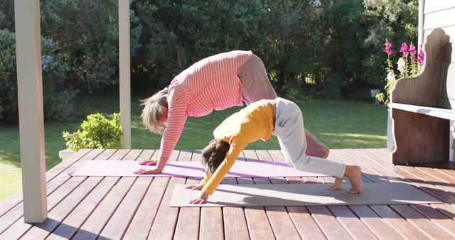 Grandparent and Grandchild Doing Yoga Outdoors on Wooden Deck - Download Free Stock Images Pikwizard.com