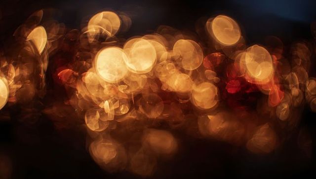 Golden bokeh night lights - warm glowing orbs, abstract urban soft focus background