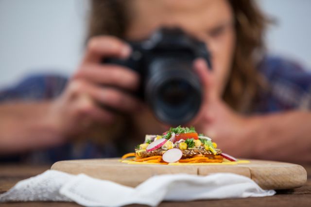 Male photographer photographing food in studio