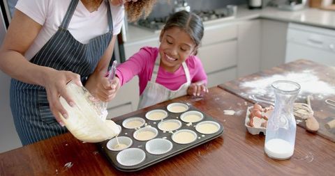 Mother and Daughter Joyful Baking in Modern Kitchen
