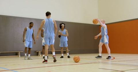 Diverse Basketball Team Practicing in Gym
