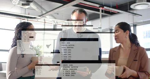 Three professionals collaborating over tablet with code overlay in modern open-plan office
