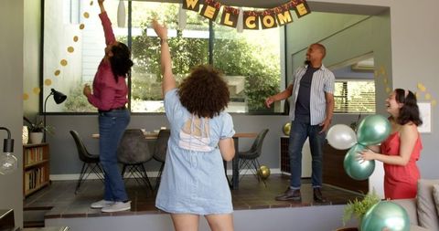 Friends Decorating for Celebration in Modern Living Area