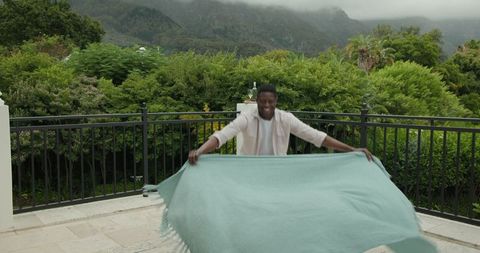 Man preparing comforting outdoor space with stunning mountain view
