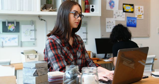 Young Woman Working on Laptop in Modern Creative Office - Download Free Stock Images Pikwizard.com