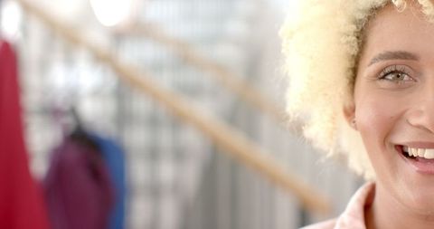 joyful young biracial woman with curly blonde hair smiling naturally - Download Free Stock Images Pikwizard.com