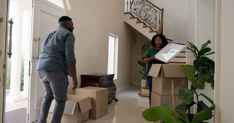 Couple unpacking and decorating new home for fresh start