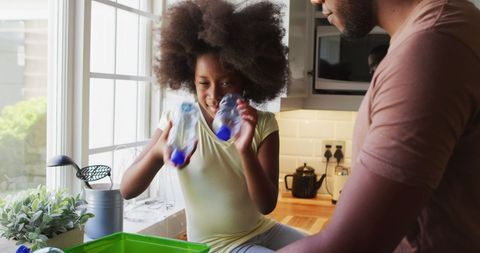 Father and Daughter Enjoy Recycling Activity in Bright Kitchen - Download Free Stock Images Pikwizard.com