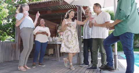 Senior Group Joyfully Celebrating Life in Sunny Garden
