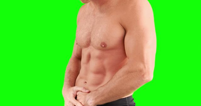 Mid section of caucasian strong man flexing muscles with copy space on green screen. Strength and fitness concept.
