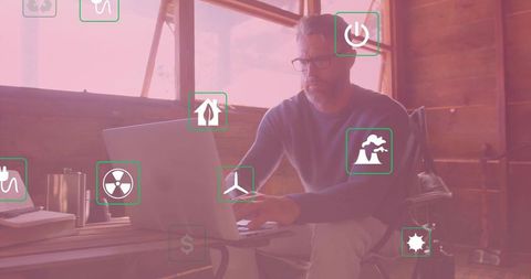 Businessman Typing on Laptop with Sustainability Icons Overlay