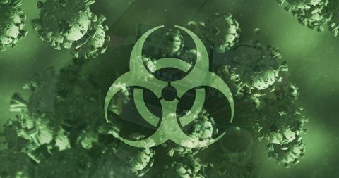 Biohazard sign with covid-19 cells on green background