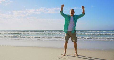 Joyful Senior Man Jumping on Ocean Beach in Sunny Weather - Download Free Stock Images Pikwizard.com