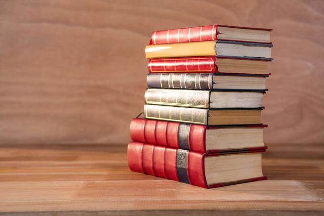 Stack of various books on a wooden table
