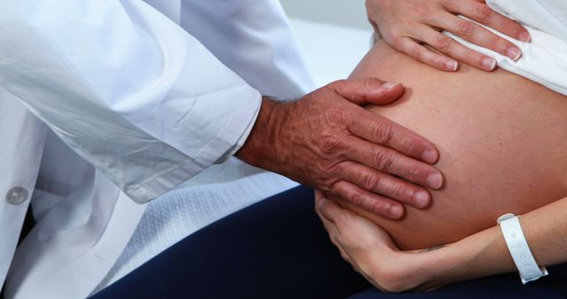 Doctor Examining Pregnant Woman's Belly During Checkup - Download Free Stock Images Pikwizard.com