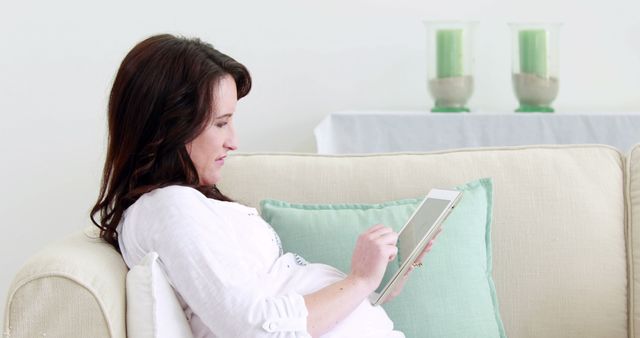 Pregnant Woman Relaxing on Sofa with Digital Tablet - Download Free Stock Images Pikwizard.com