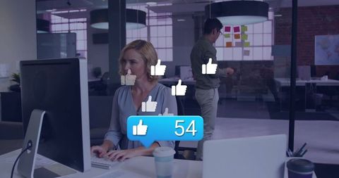 Office Worker Engaged Online with Floating Social Media Likes