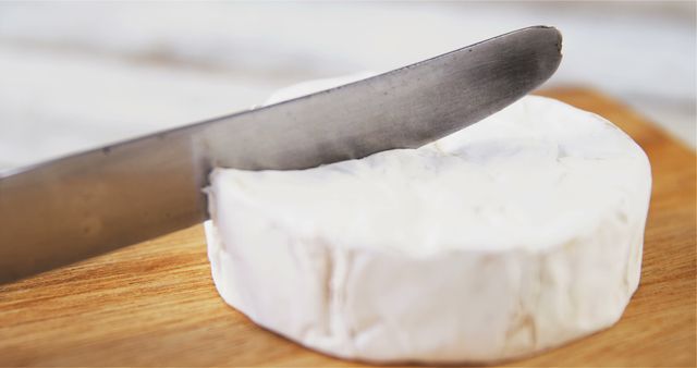 Close-Up of Knife Cutting Soft Brie Cheese on Wooden Board - Download Free Stock Images Pikwizard.com