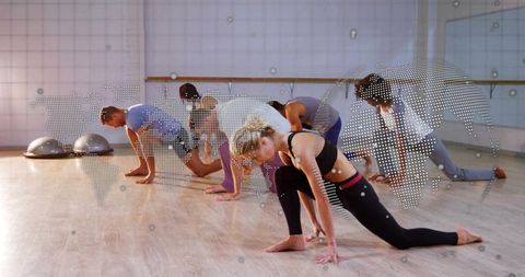 Group Performing Low Lunge Stretch in Fitness Studio with Barre and Digital World Map Overlay