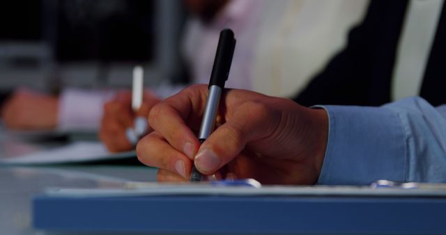 Hand Writing on Notepad During Business Meeting in Office - Download Free Stock Images Pikwizard.com