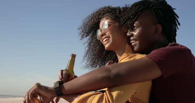 Couple Embracing on Beach at Sunset Holding Beverage - Download Free Stock Images Pikwizard.com