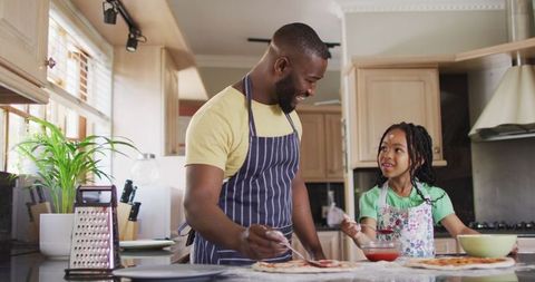 Father and Daughter Bonding Over Homemade Pizza in Kitchen