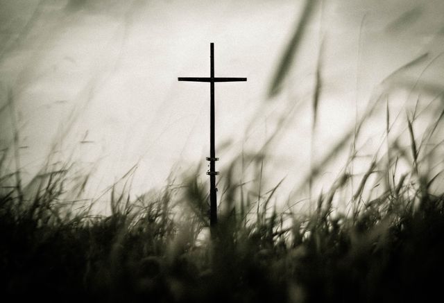 Serene Cross in Field with Blurry Grass Foreground - Download Free Stock Photos Pikwizard.com
