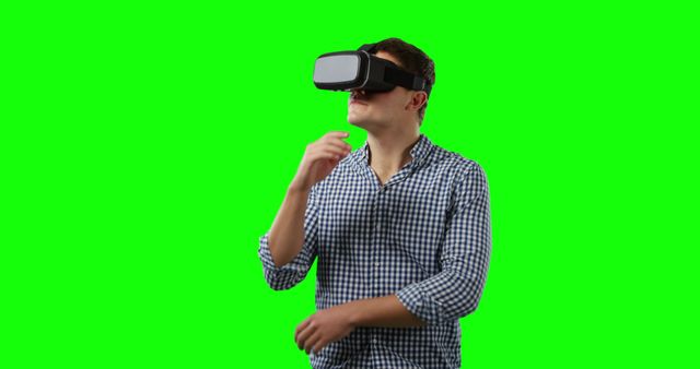 Man Wearing Virtual Reality Headset against Green Background - Download Free Stock Images Pikwizard.com