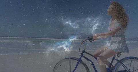 Woman Biking on Beach with Cosmic Background Illusion