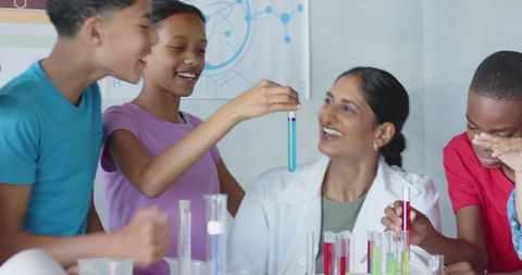 Engaged science teacher guiding students in chemistry experiment