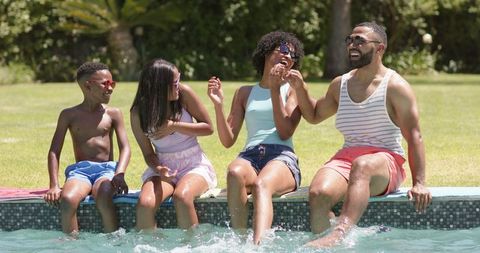 Happy Family Splashing Water by Swimming Pool - Download Free Stock Images Pikwizard.com