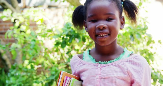 Smiling African American Girl Holding Books Outdoors - Download Free Stock Images Pikwizard.com