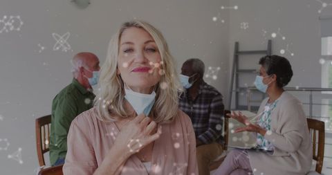 Seniors with Face Masks and Floating Virus Icons in Social Setting