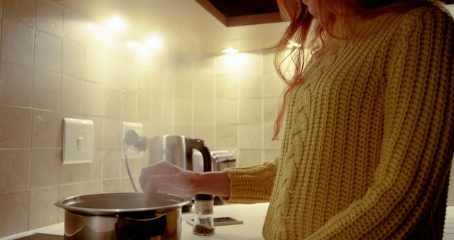 Woman Cooking at Home in Cozy Kitchen in Yellow Sweater - Download Free Stock Images Pikwizard.com