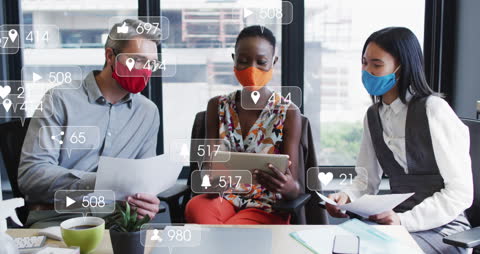 Diverse Team Engaging with Social Media Interaction in Modern Office