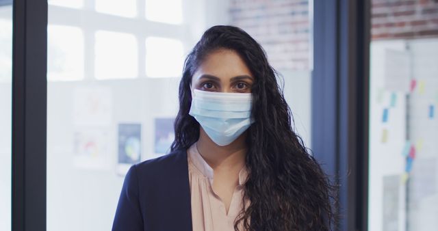 Professional Woman Wearing Mask in Office Setting - Download Free Stock Images Pikwizard.com