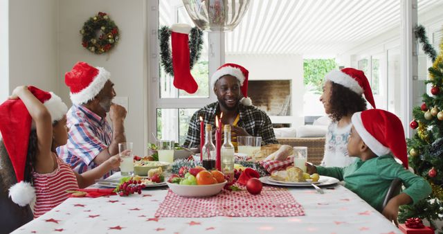 Family Enjoying Christmas Dinner Together in Festive Dining Room - Download Free Stock Images Pikwizard.com