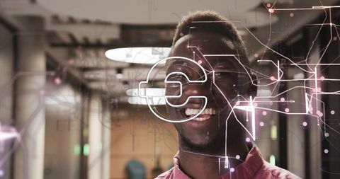 Tech Professional Smiling with Digital Overlay in Modern Office