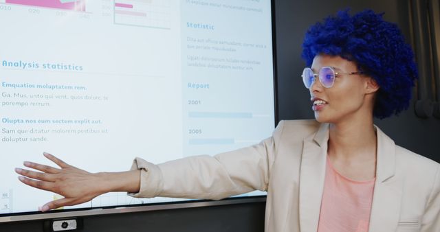 Businesswoman with Blue Wig Presenting Data on Whiteboard - Download Free Stock Images Pikwizard.com